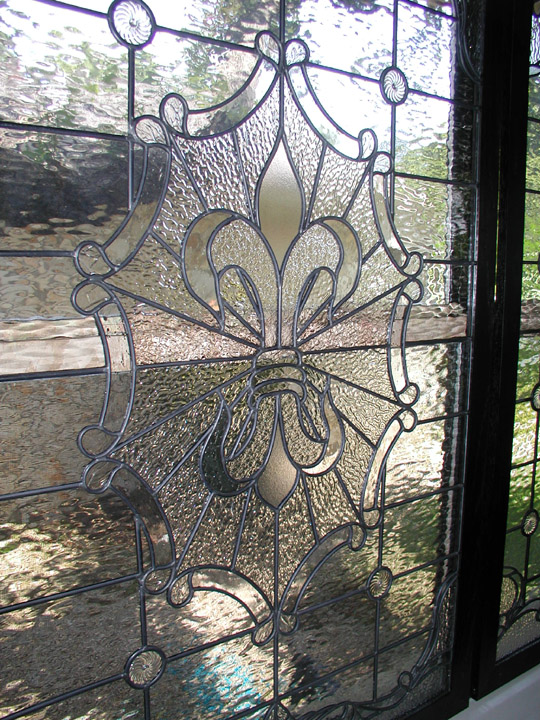 Custom leaded clear textured glass window set featuring a fluer di lis and victorian elements